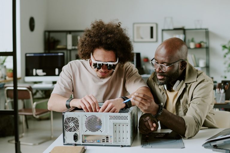 Medium,Close,Up,Of,Biracial,Colleagues,Repairing,Computer,Together,At