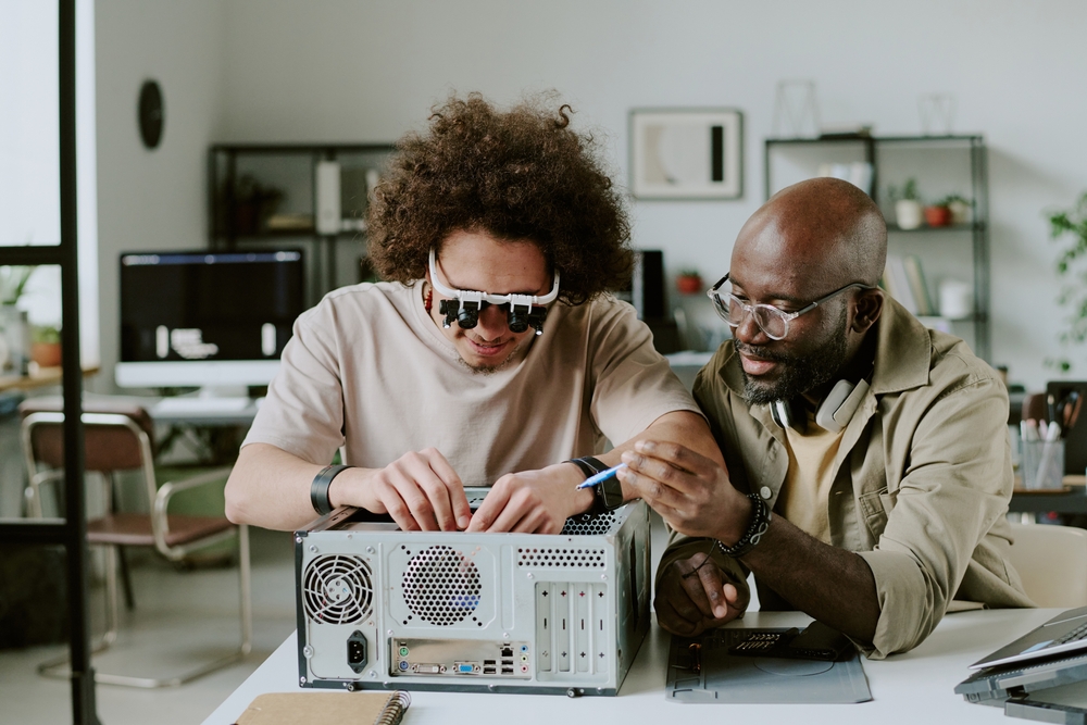 Medium,Close,Up,Of,Biracial,Colleagues,Repairing,Computer,Together,At
